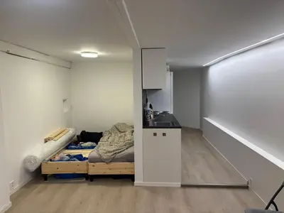 a small room with a bed and a kitchen at Family friendly apartment with parking in Bergen