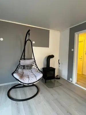 a swing chair in a living room with a floor at Your home in Kristiansund in Kristiansund
