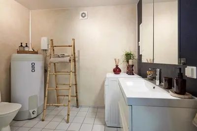 a bathroom with a sink and a toilet and a refrigerator at Tasteful apartment in Sogndal with parking in Sogndal