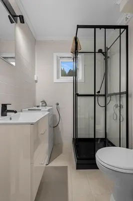 a bathroom with a shower and a toilet and a sink at Apartment in idyllic Kristiansund in Kristiansund