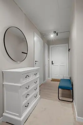a bathroom with a white dresser and a mirror at Apartment in idyllic Kristiansund in Kristiansund