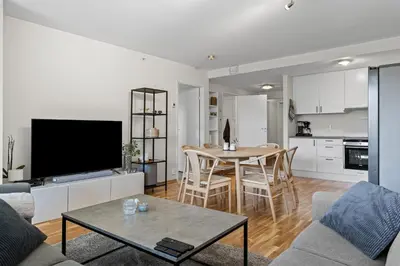 a living room with a couch and a table with a television at Convenient Bergen Stay with Easy Transport Connections in Bergen