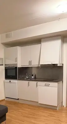 a kitchen with white cabinets and a microwave at Modern apartment near Oslo in Lii