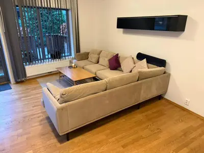 a living room with a couch and a table at Modern apartment near Oslo in Lii