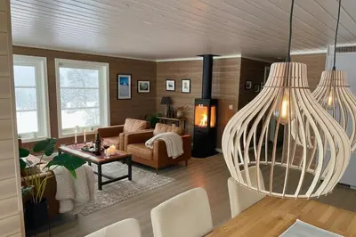 a living room with a couch and a table at Cozy family cabin with fireplace and near ski trails in Lii