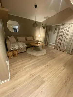 a living room with a table and a couch at Furnished outhouse in Bergen