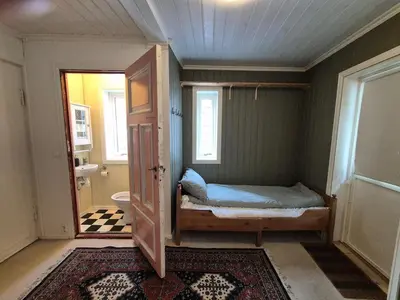 a small room with a bed and a bathroom at Penthouse apartment with garden and amazing view, in Bergen