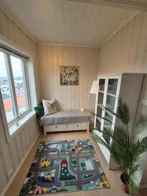 a room with a bench and a rug on the floor at Penthouse apartment with garden and amazing view, in Bergen