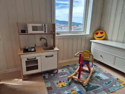 a kitchen with a toy stove and a microwave at Penthouse apartment with garden and amazing view, in Bergen