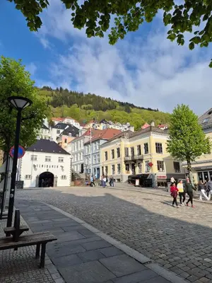 a group of people walking down a street with buildings at Penthouse apartment with garden and amazing view, in Bergen