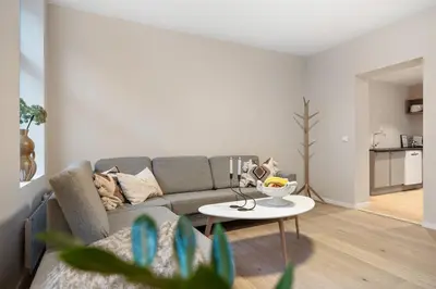 a living room with a couch and a table at Large apartment, central and quiet in Ålesund in Ålesund