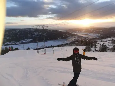 a person standing in the snow on a ski slope at Retreat ved Spa hotell med Ski in & out, Norefjell in Surteberg
