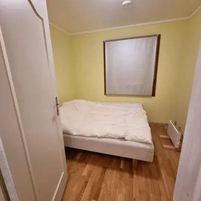 a small bedroom with a bed and a window at A house for rent in Osen, only 45 min from Trysil in Åmot