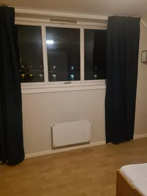 a room with a window and a radiator in front of it at Holiday home Hemnskjel in Hitra