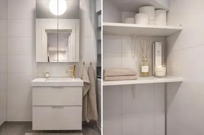 a white bathroom with a sink and a mirror at leilighet in Bergen