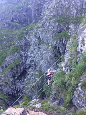 a person is on a rope on a mountain at Hjelledalen Hyttesenter in Hjelle