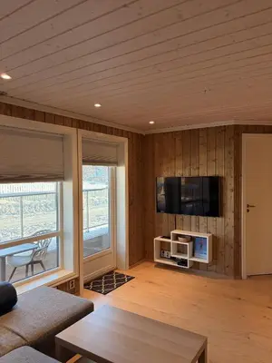 a living room with a flat screen tv on a wall at Apartment in the Center of Geilo in Geilo