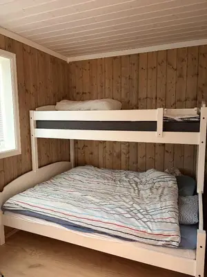 two bunk beds in a room with wooden walls at Apartment in the Center of Geilo in Geilo