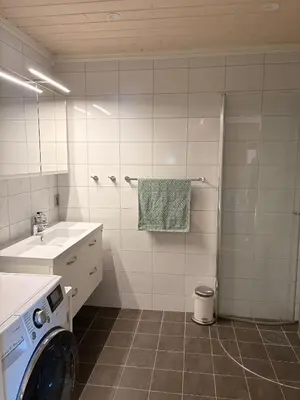 a bathroom with a washing machine and a sink at Apartment in the Center of Geilo in Geilo