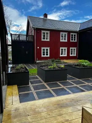 a red house with three planters in front of it at NerSalberg Farm