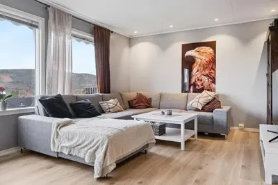 a living room with a couch and a table at Enebolig med 5 soverom in Lii