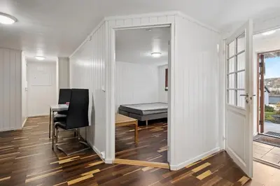 a room with a bedroom with a bed and a desk at Enebolig med 5 soverom in Lii