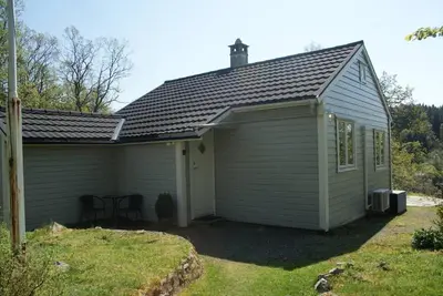 a small shed with a table in the yard at Charming sea view in Bergen