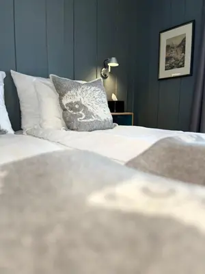 a close up of a bed with a pillow on it at Granavolden Hotel & Gjæstgiveri in Gran