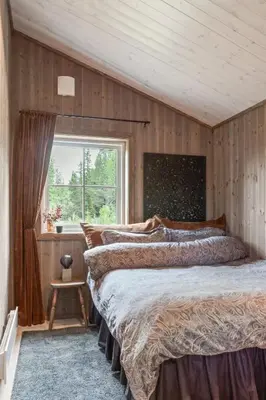 a bedroom with two beds and a window at Solglimt, mountain cabin in Golsfjellet with jacuzzi in Gol
