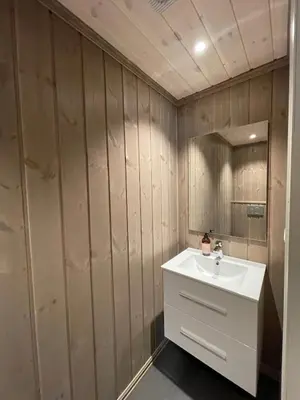 a bathroom with a white sink and a mirror at Modern and cozy cabin near ski slopes in Beitostøl