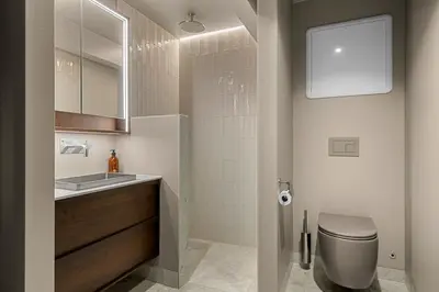 a bathroom with a toilet and a sink and a mirror at Villa with pool and panorama - friend trip,company outing in Trondheim