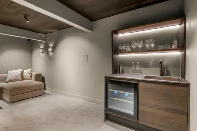 a bathroom with a sink and a couch in a room at Villa with pool and panorama - friend trip,company outing in Trondheim