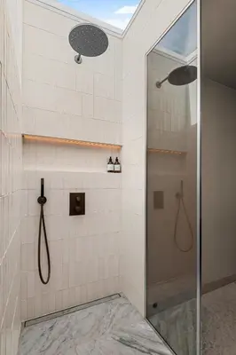 a shower with a glass door in a bathroom at Villa with pool and panorama - friend trip,company outing in Trondheim