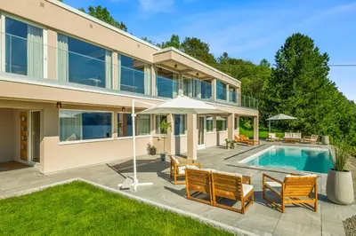 a house with a swimming pool and a patio at Villa with pool and panorama - friend trip,company outing in Trondheim