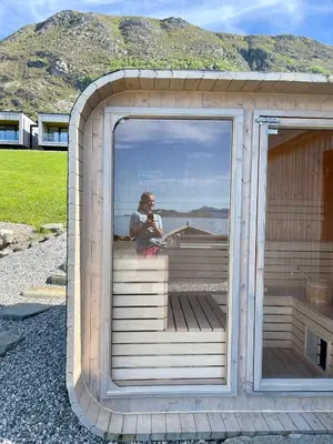 a person reflection in a window of a building at 5 Bedroom House at Hakallestranda in Sandvik