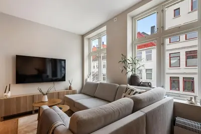 a living room with a couch and a flat screen tv at Renovated Apartment in Central Area in Bergen