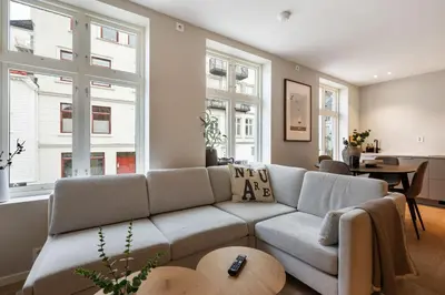 a living room with a couch and a table at Renovated Apartment in Central Area in Bergen
