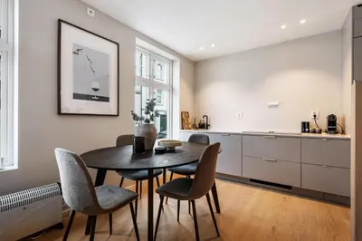 a kitchen and dining room with a table and chairs at Renovated Apartment in Central Area in Bergen