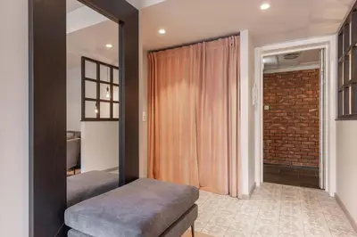 a bedroom with a mirror and a brick wall at Nice apartment with three bedrooms in the middle of Bergen! in Bergen