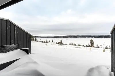 a snow covered porch with a view of a snow covered field at Modern apartment in Golsfjellet in Gol