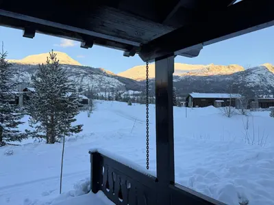 a view from the porch of a house in the snow at Stylish cabin near Hemsedal ski resort, 200 m to slopes & lift in Hemsedal