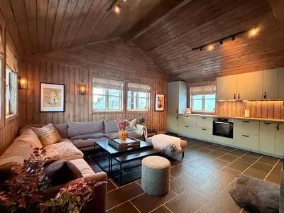 a living room with a couch and a table at Stylish cabin near Hemsedal ski resort, 200 m to slopes & lift in Hemsedal