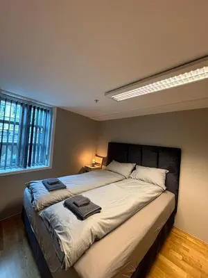 a bedroom with a large bed with two towels on it at Modern apartment in central Trondheim in Trondheim