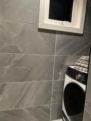 a microwave in a kitchen with a tile wall at Nordic Apartment near by the city in Bergen