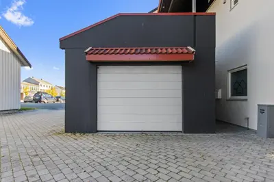 a black and white garage with a red roof at Konsul Moes Gate 4 in Verdal