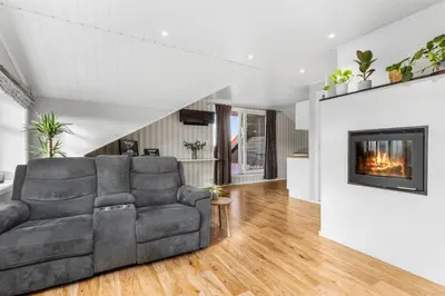 a living room with a couch and a fireplace at Konsul Moes Gate 4 in Verdal