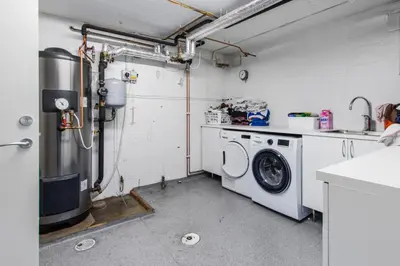 a laundry room with a washing machine and a washer at Konsul Moes Gate 4 in Verdal