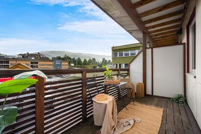 a balcony with a table and a view at Big apartment - Prime Location - Middle of Voss in Vossevangen