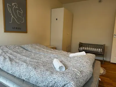 a bedroom with a bed with two towels on it at Big apartment - Prime Location - Middle of Voss in Vossevangen