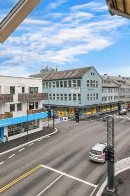 a view of a street with a building and a car at Big apartment - Prime Location - Middle of Voss in Vossevangen